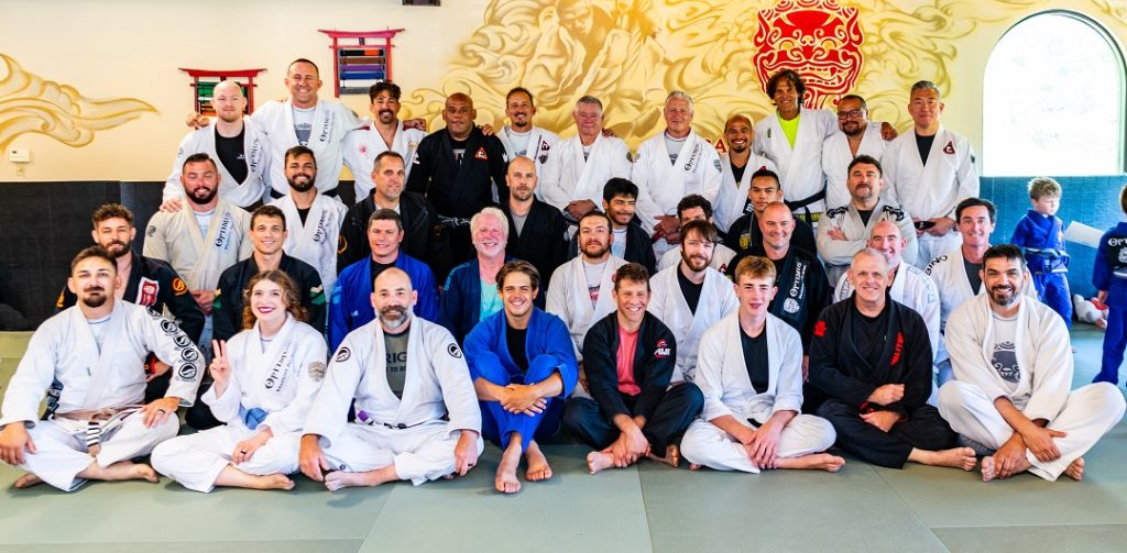 Group of Jiu-Jitsu black belts alongside Optimus Brazilian Jiu-JItsu students