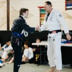 Coach Andrew Receiving his blue belt in BJJ