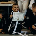 Young boy proud of all the work he's in jujitsu